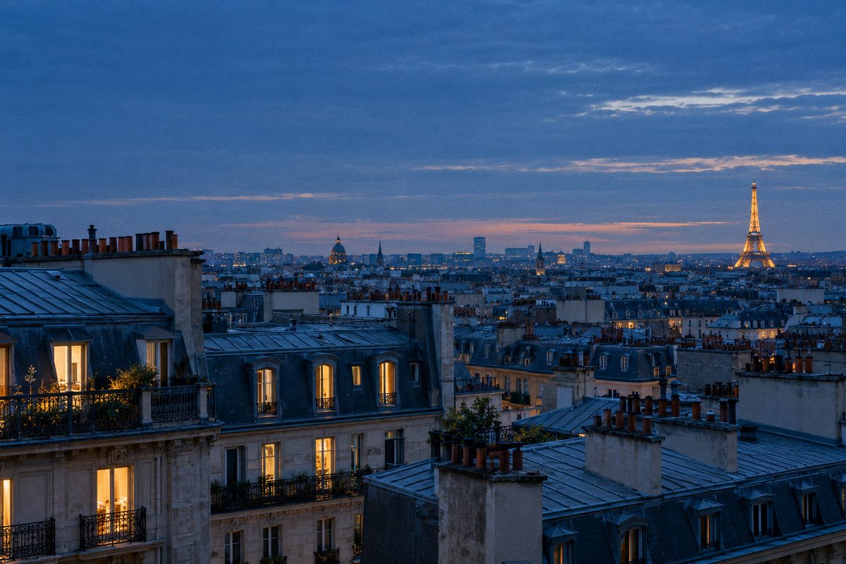 Paris rooftops at blue hour with the Eiffel Tower in the distance